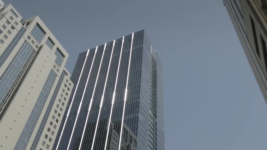 The sky is clear above these tall buildings