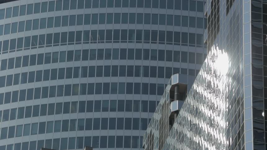 Tall buildings are reflecting the bright sun