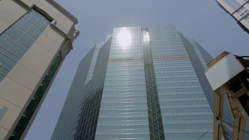 A row of buildings line a clear sky
