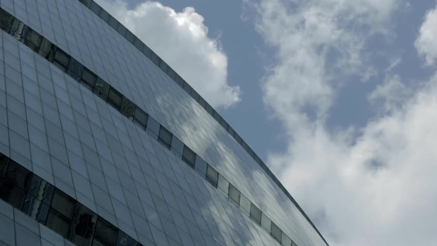 Clouds reflect off the windows of this building