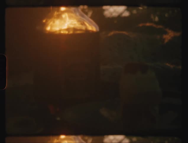 The lamp is on as the sun sets