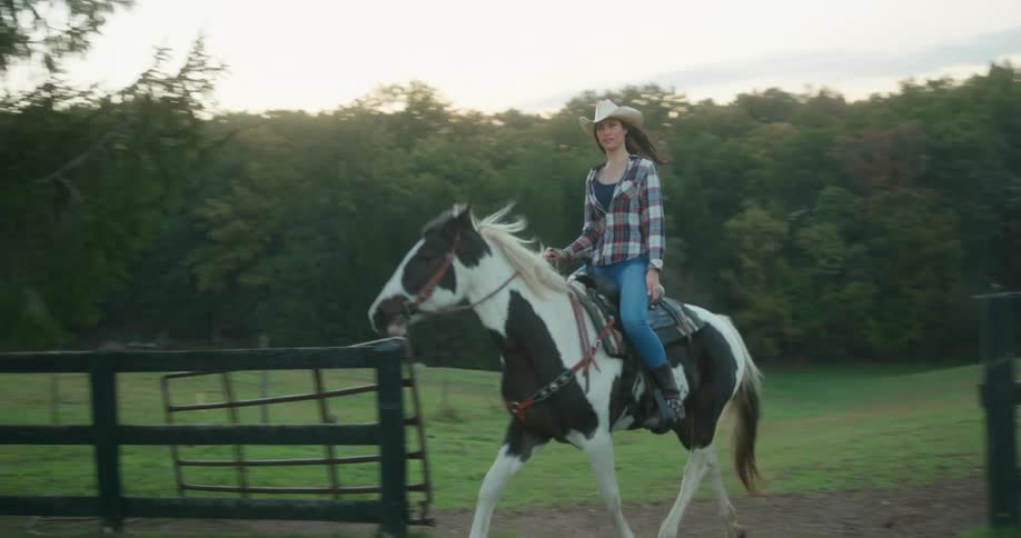 Lady riding a horse in a rural area during the day