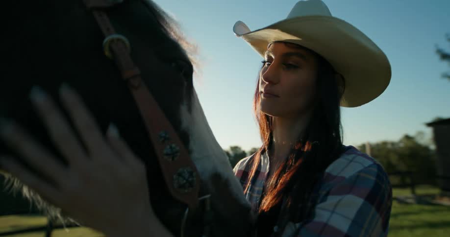 A woman is petting her horse
