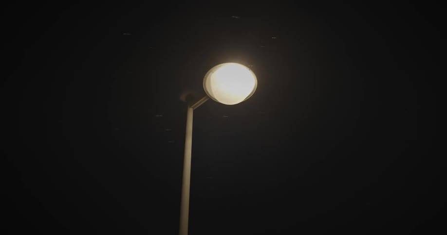 A streetlight shining during the dark night