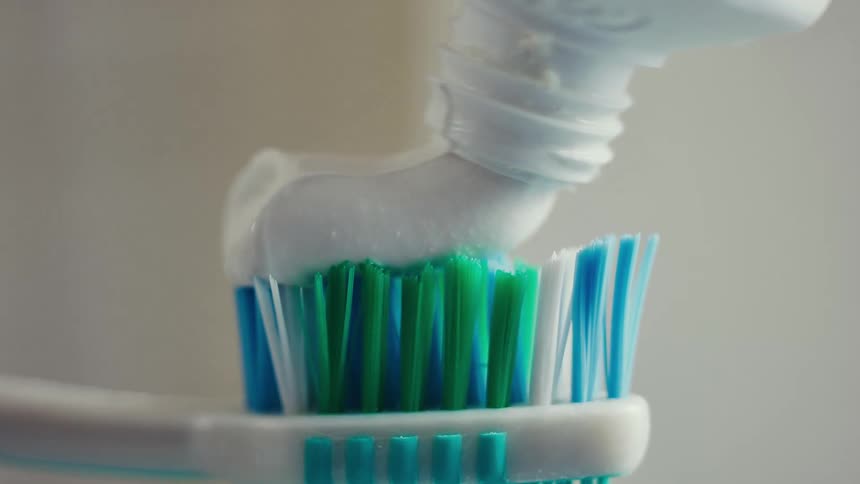 Toothpaste is placed on the brush