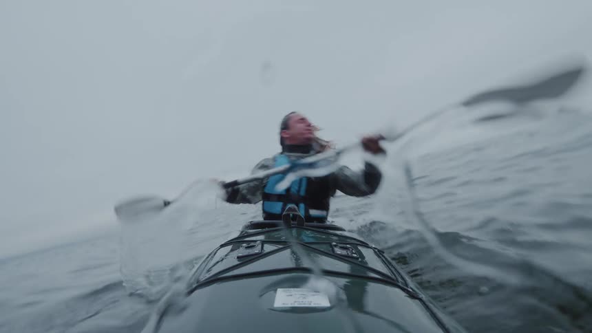 Kayaker rotates his kayak and submerges briefly