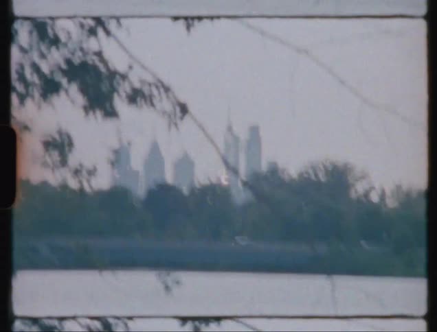 View of a lake and just behind a highway in the middle of a metropolis with skyscrapers