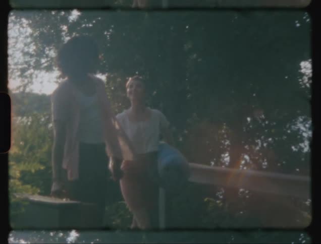 Couple walking hand in hand on a bridge amid nature