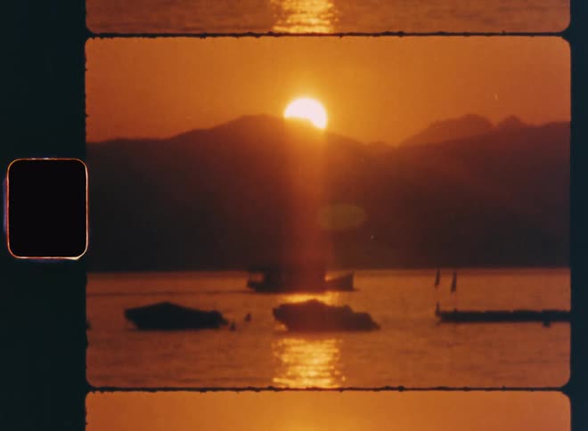 A boat is traveling past the mountains