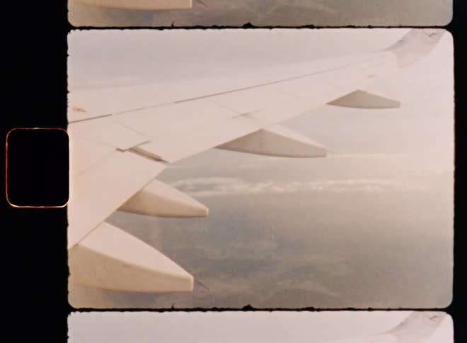 View from onboard a passenger jet flying over the land during the daytime