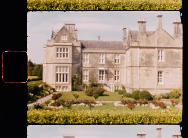 A mansion with a beautiful garden on a sunny day