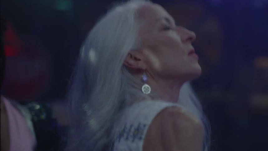 An elegant woman dancing at a party