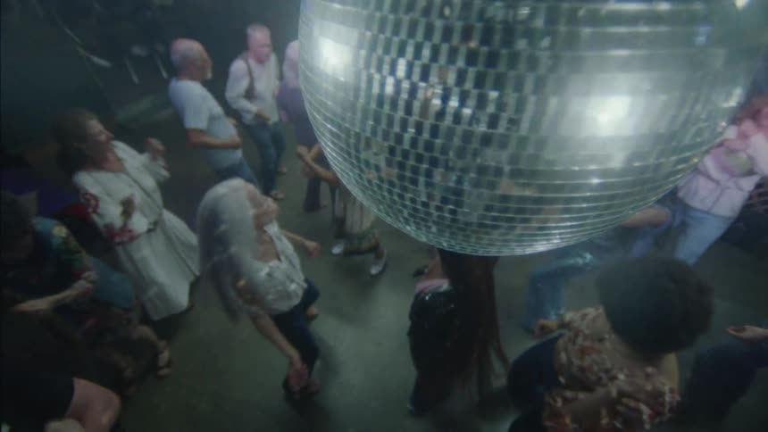 Men and women dancing at a party at night