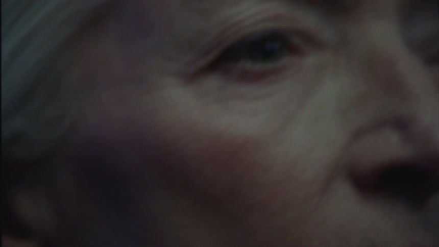 An elderly woman dancing at a party at night