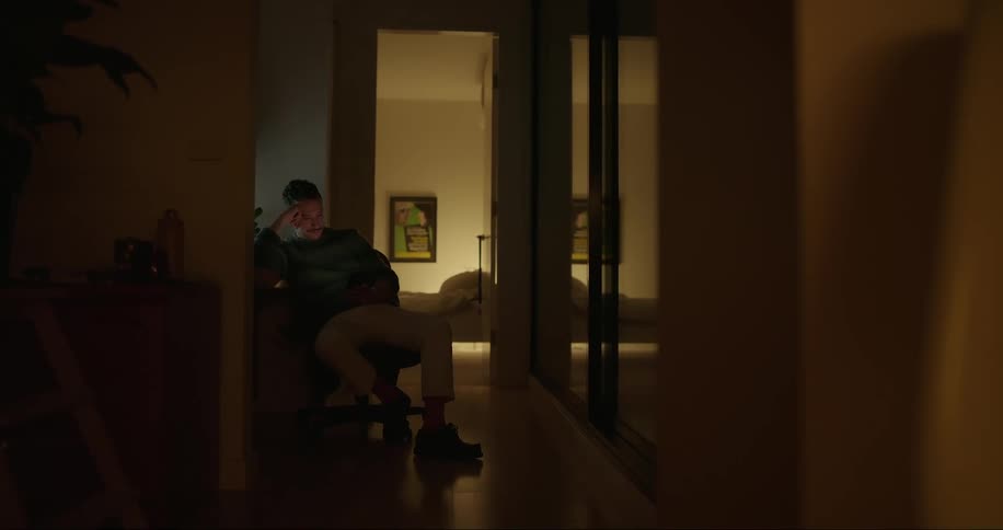 Man sitting in a chair using his cell phone