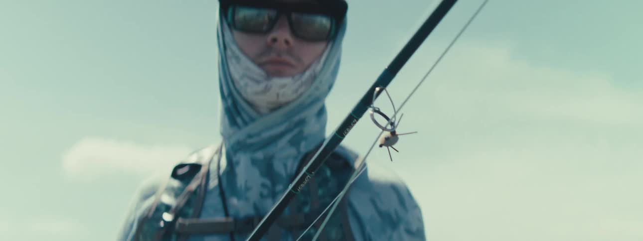 Portrait of a man with sunglasses and with a fishing rod