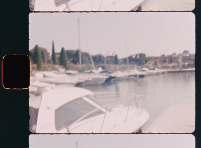 Lots of boats are parked in a harbor on an overcast summer day