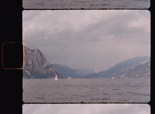 Sailboats sailing in the sea waters with mountains landscape