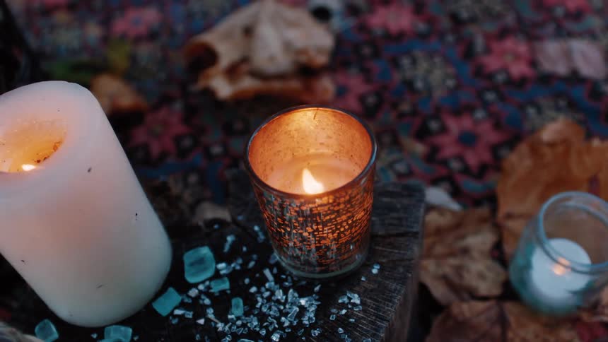 Candles lit on the ground outdoors