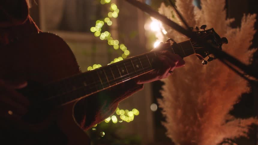 A woman is performing with a guitar