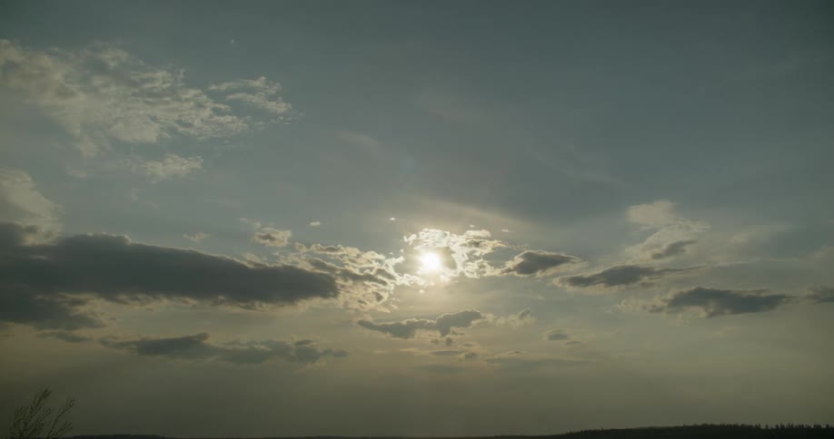 A passing cloud briefly shading a radiant sun in the sky
