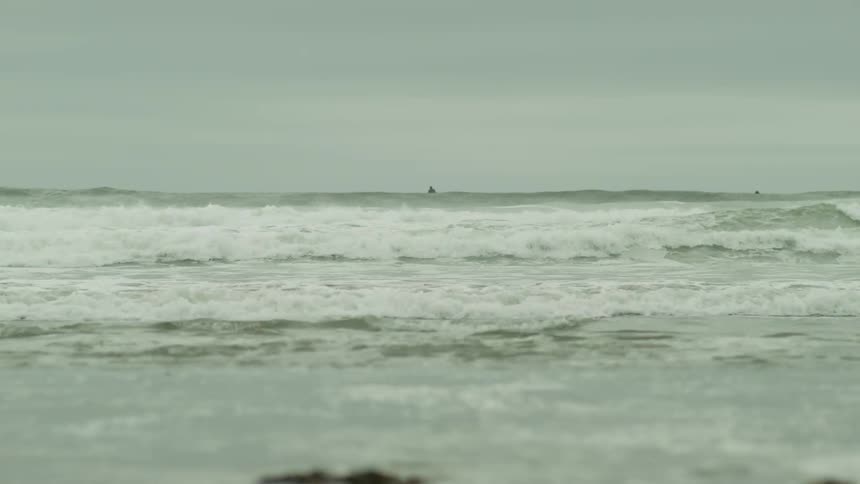 Panorama of ocean waves on a beach