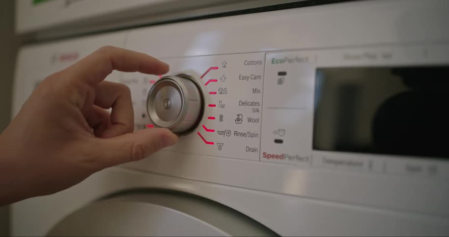 A person programming the washing machine