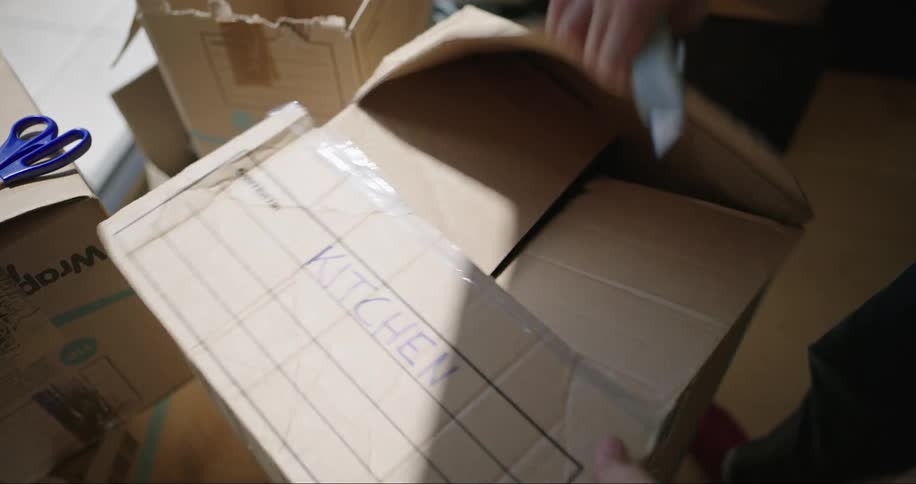 A person is cutting open a box