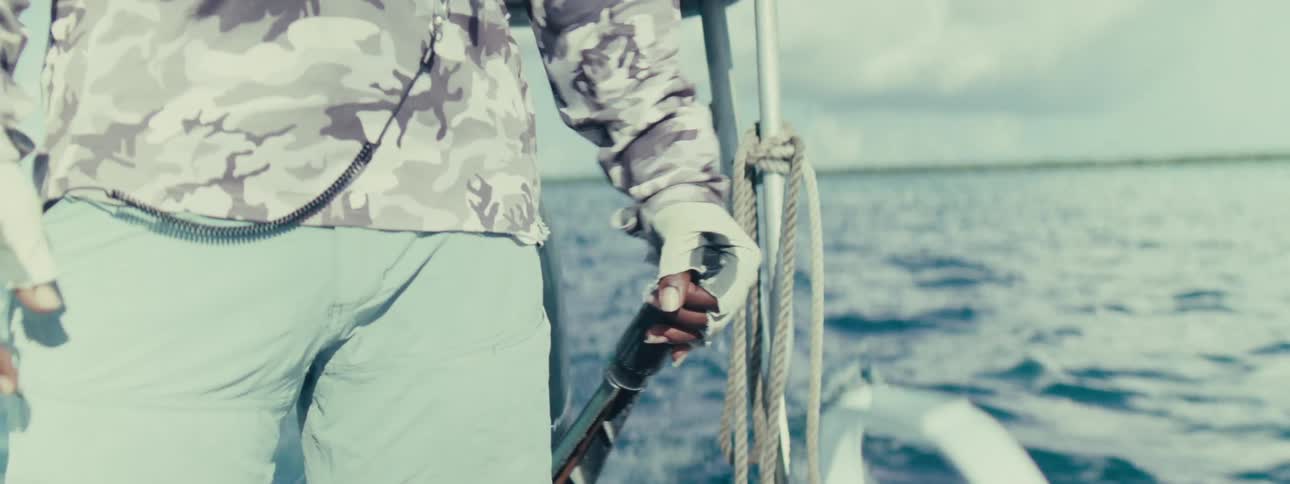 A person piloting a boat across the ocean
