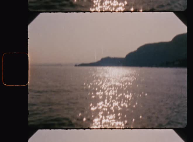 Gazebo allows view of promontory across reflective water on sunny day