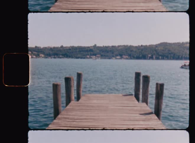 A wooden pier extends over the calm body of water offering a tranquil spot to enjoy the scenery