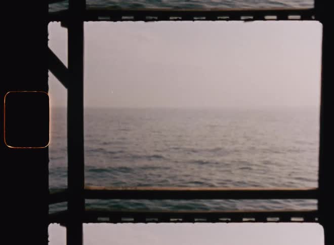 A wooden deck with a view of the ocean horizon