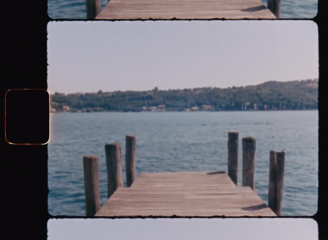 A wooden pier extends over the calm body of water offering a tranquil spot to enjoy the scenery