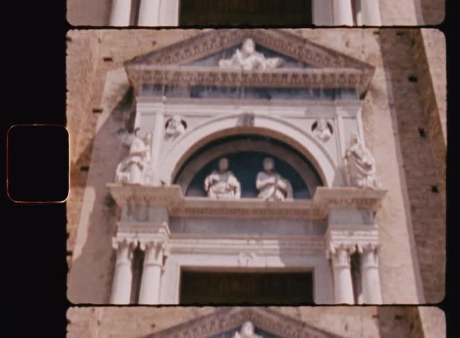 A tall church with statues above the arch