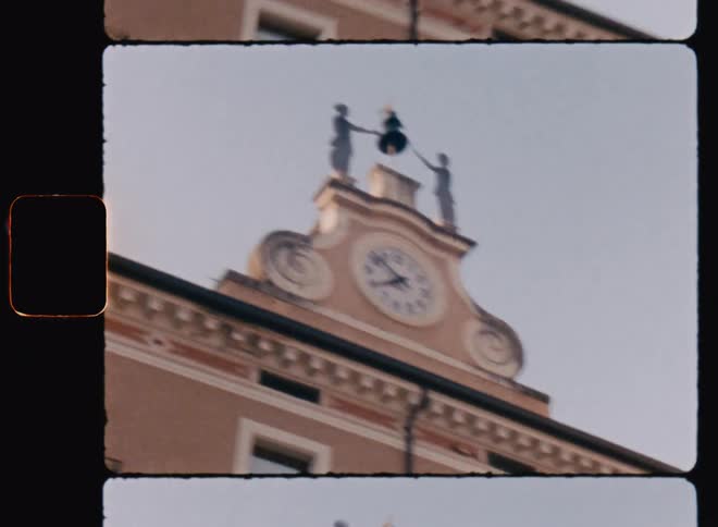 View of a clock on top of a building with a bell