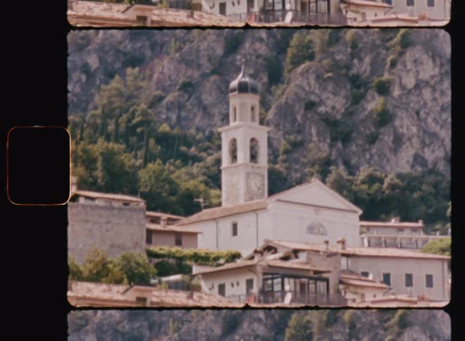 View of a church with a tower next to a mountain