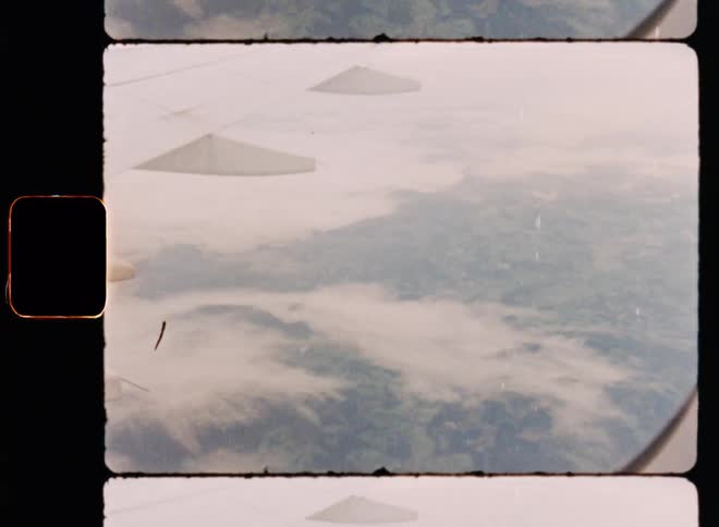Clouds and mountains seen from an airplane window