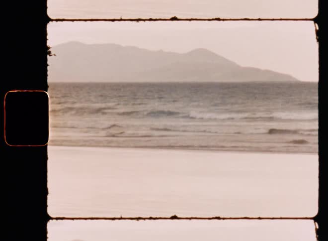 Waves in the shoreline of a beach caught on vintage film