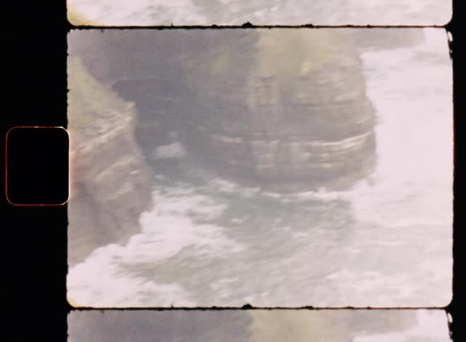 A region of mountains facing the sea that is choppy with waves