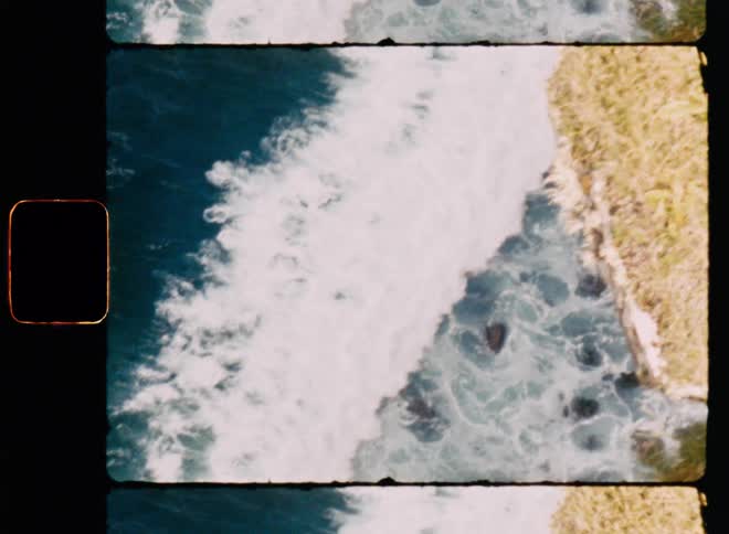 Aerial of the sea with waves breaking on the shore