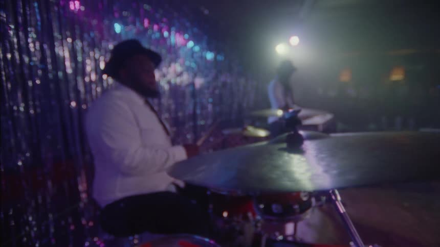 A man playing the drums at a party