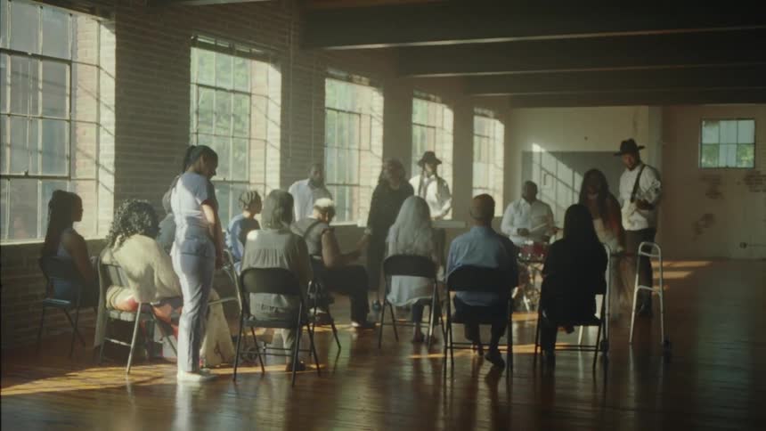 People in an indoor room watching a music band performing
