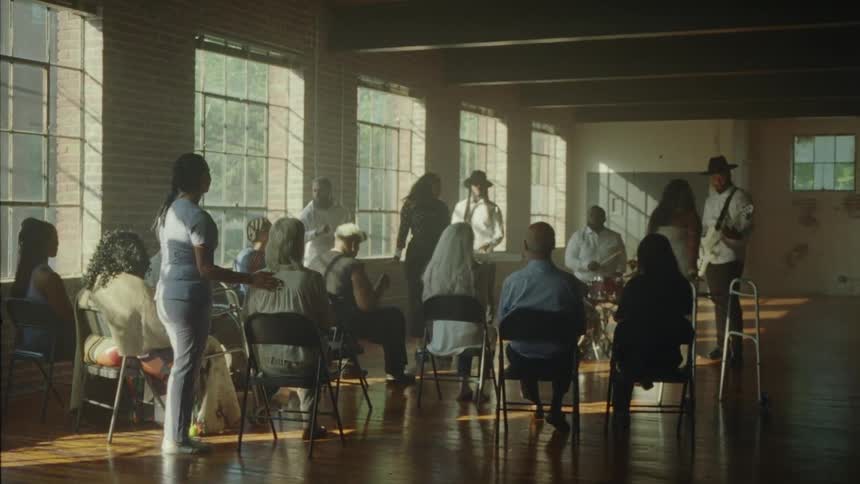 A musical band playing for a group of seated elderly people
