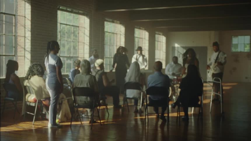 A group of people singing in a choir in the room
