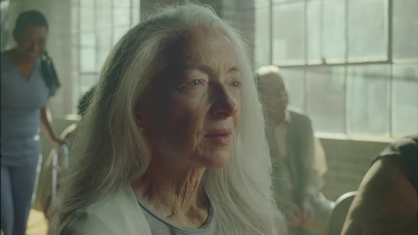 Portrait of a lady sitting in an indoor room sighing a feeling of happiness