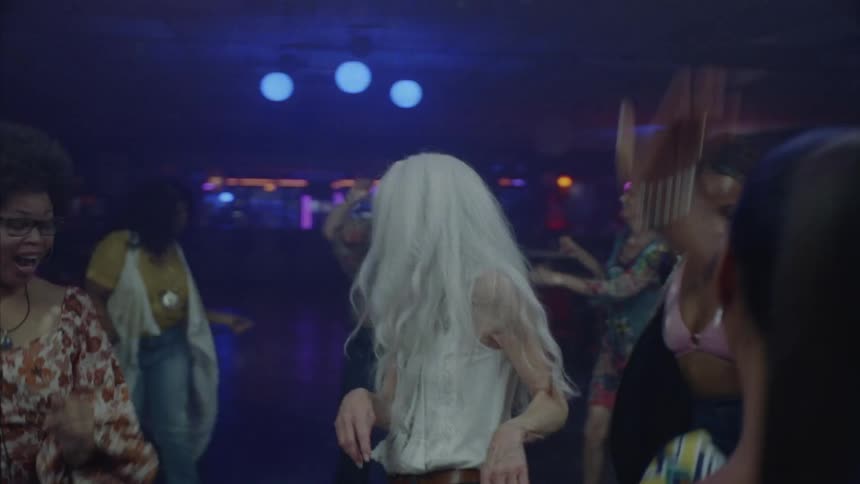 Vibrant and spry mature woman dancing at a night club