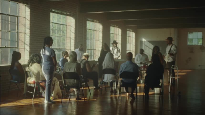 Some people are dancing and others are sitting and watching them