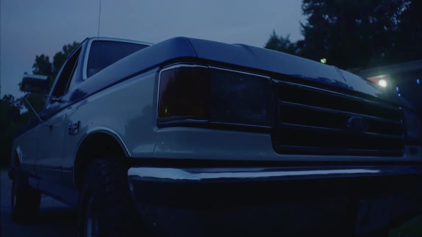 A headlight of a parked car goes out