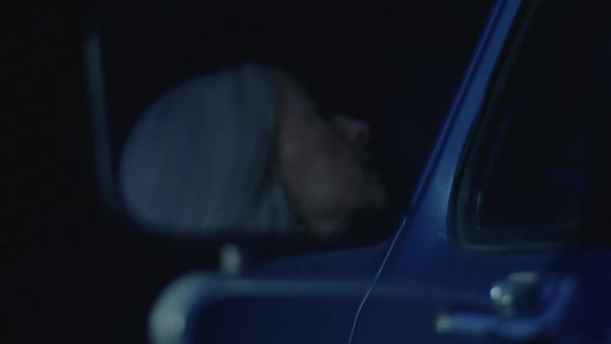 A woman getting out of her car at night
