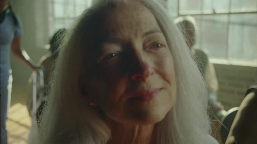 A woman smiles while she listens to music